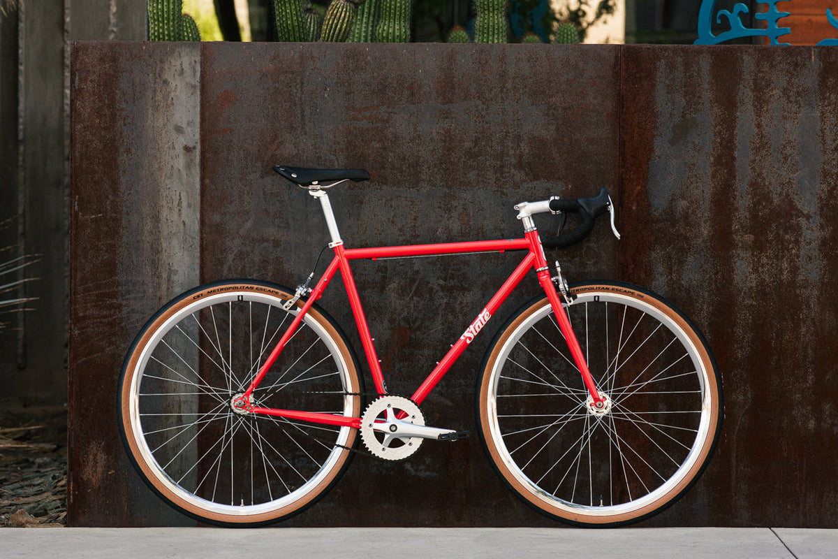 State Bicycle Co. 4130 Tropical Red fixed gear single-speed bike, side view
