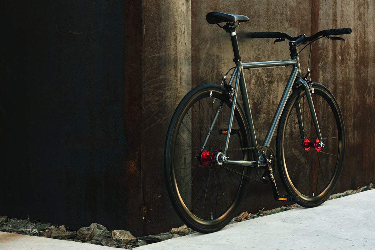 State Bicycle Co. Core-Line Earthstone seen from the rear, lifestyle shot