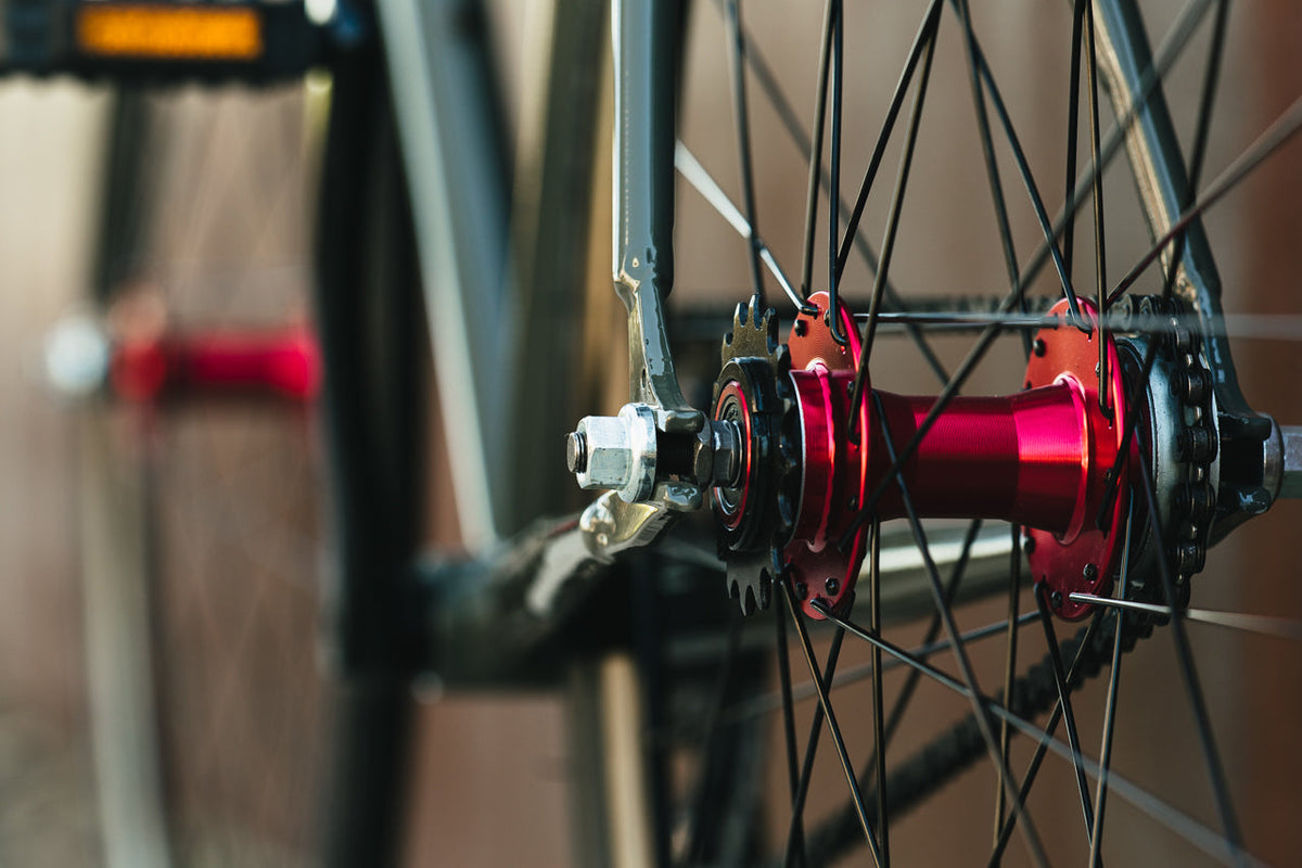 State Bicycle Co. Core-Line Earthstone red hub detail, lifestyle shot