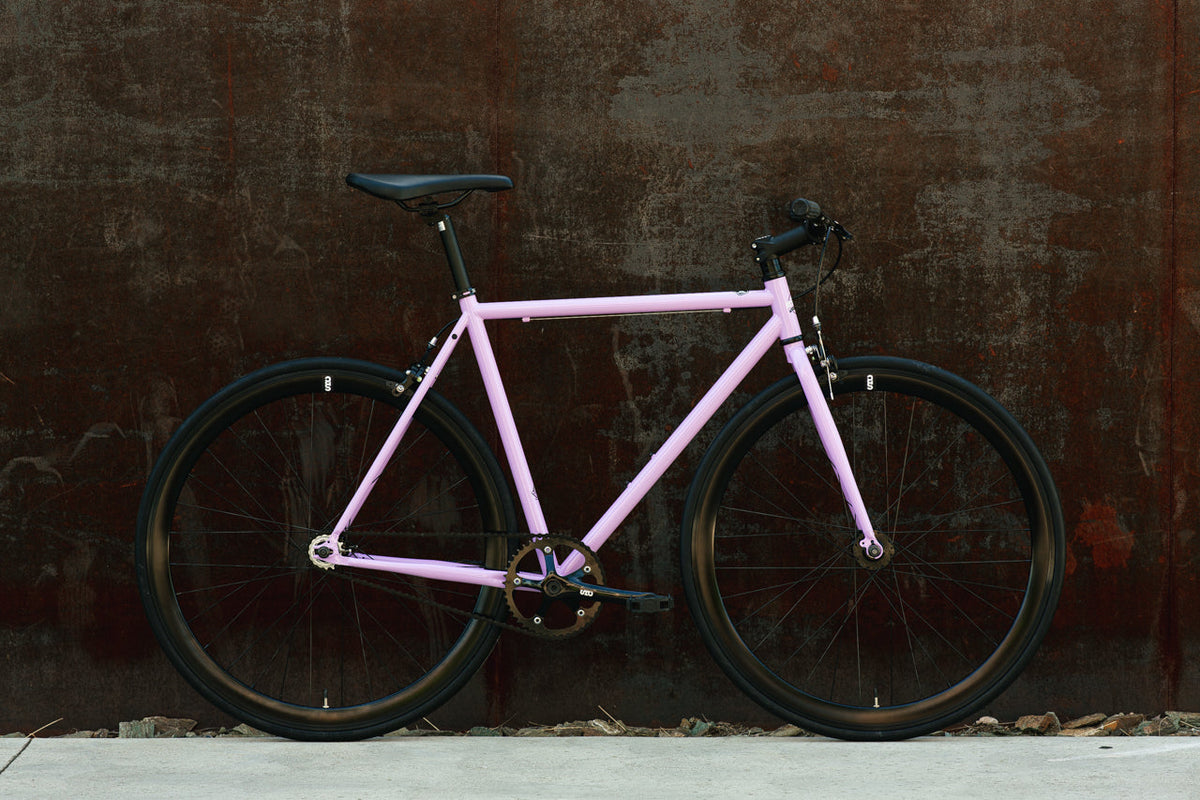 State Bicycle Co. Core-Line Lavender Haze city bike, side lifestyle shot