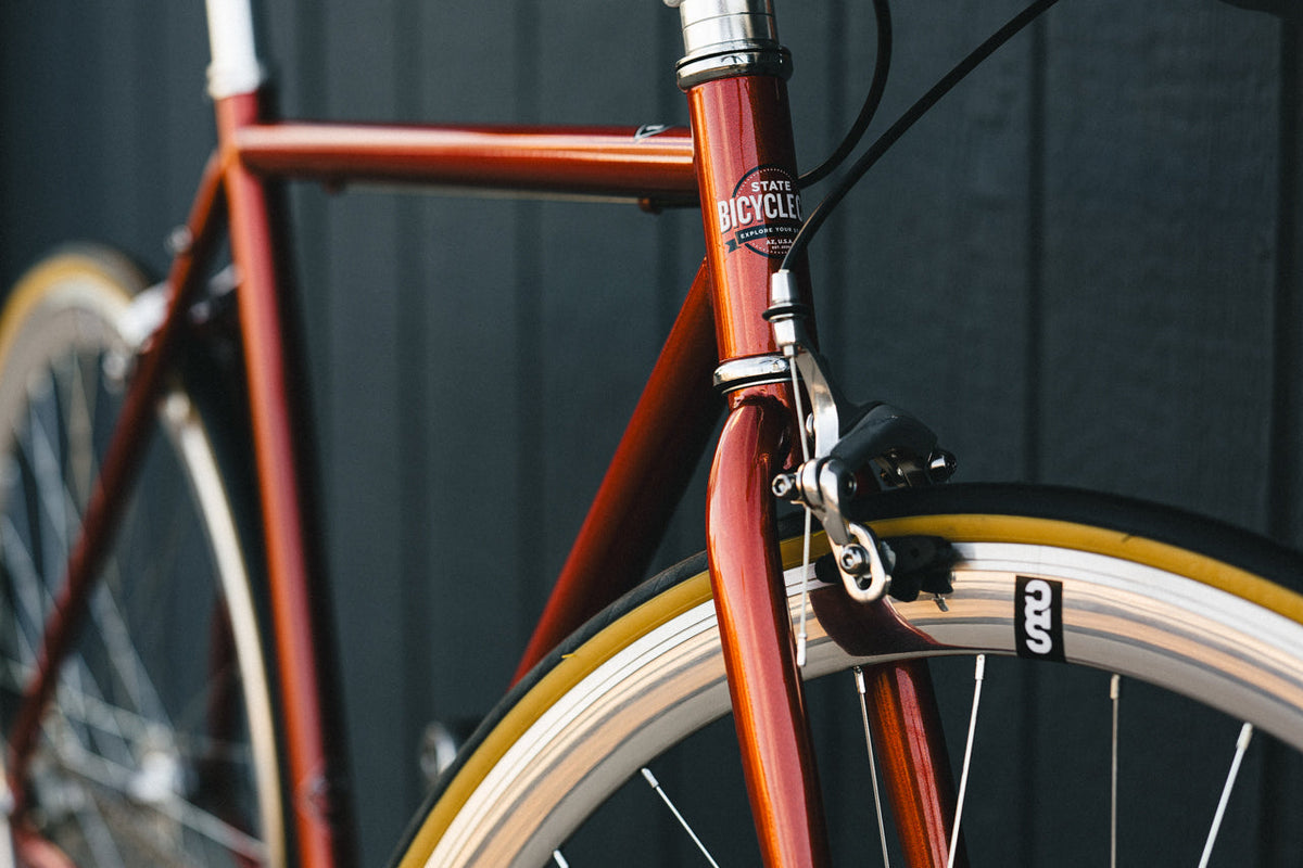 State Bicycle Co. Core-Line Lucky Penny copper front end detail, lifestyle shot