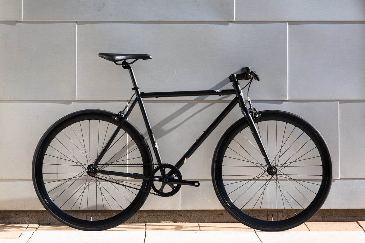 State Bicycle Co. Core-Line Wulf matte black city bike, side lifestyle shot