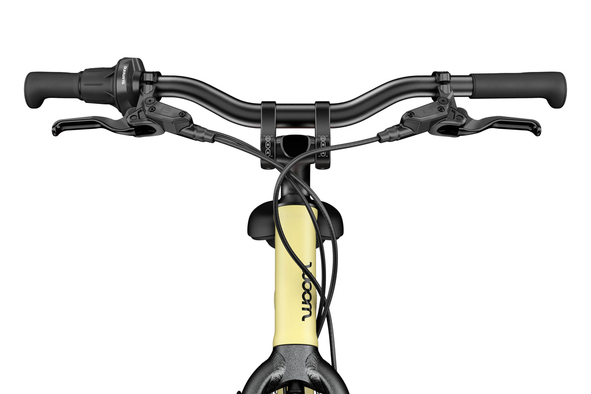 WOOM Explore 4 Mellow Yellow 20-inch kids bike front view